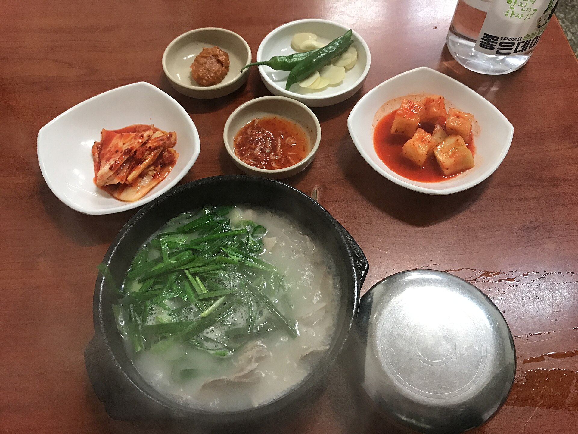Dwaeji gukbap pork rice soup served with side dishes