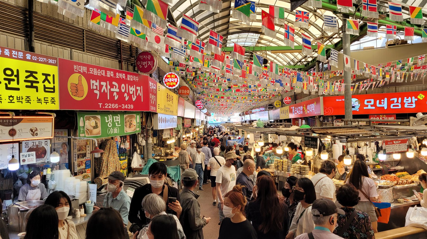 Busy food alley inside Gwangjang Market in Seoul