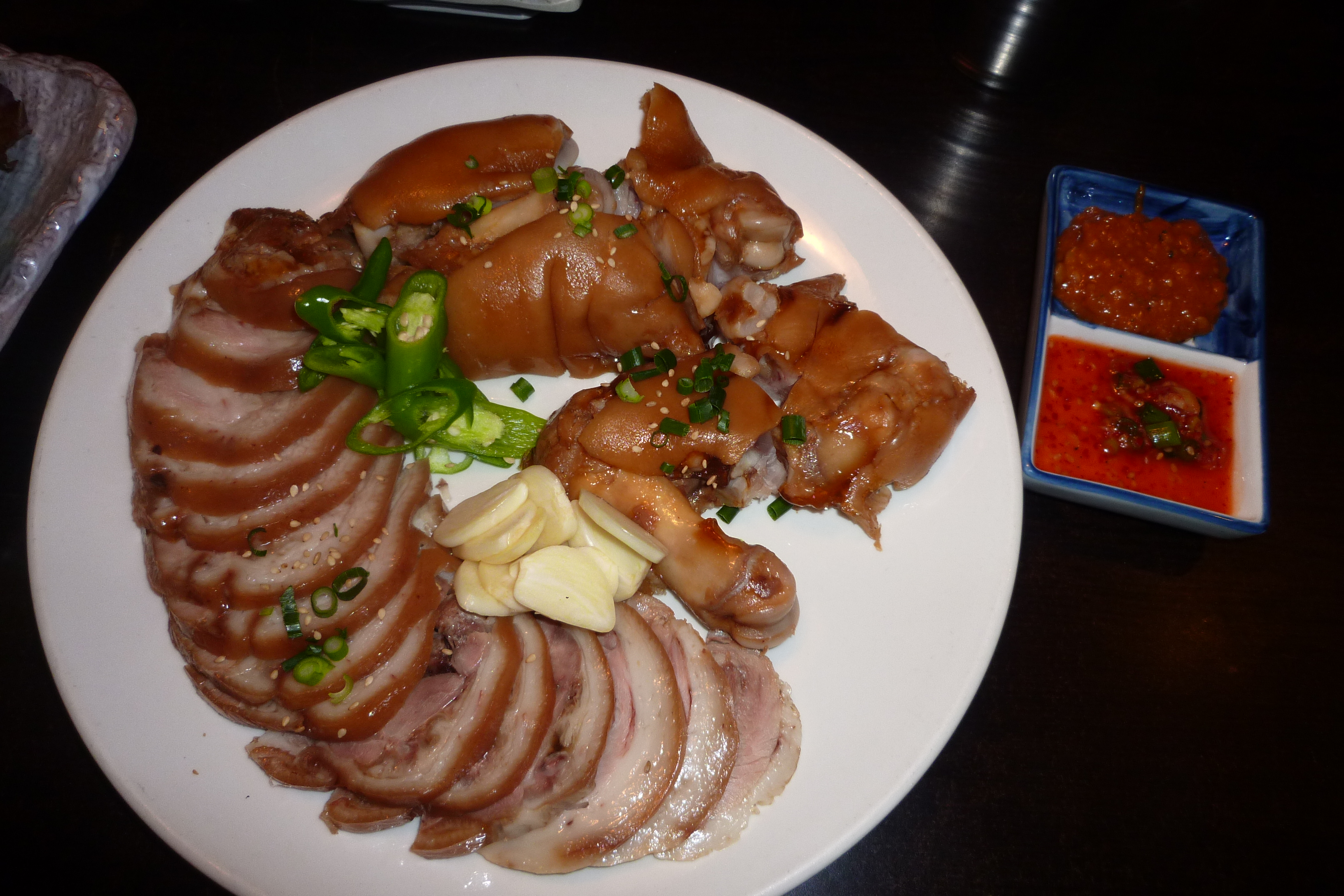 Sliced jokbal on a plate with sauce