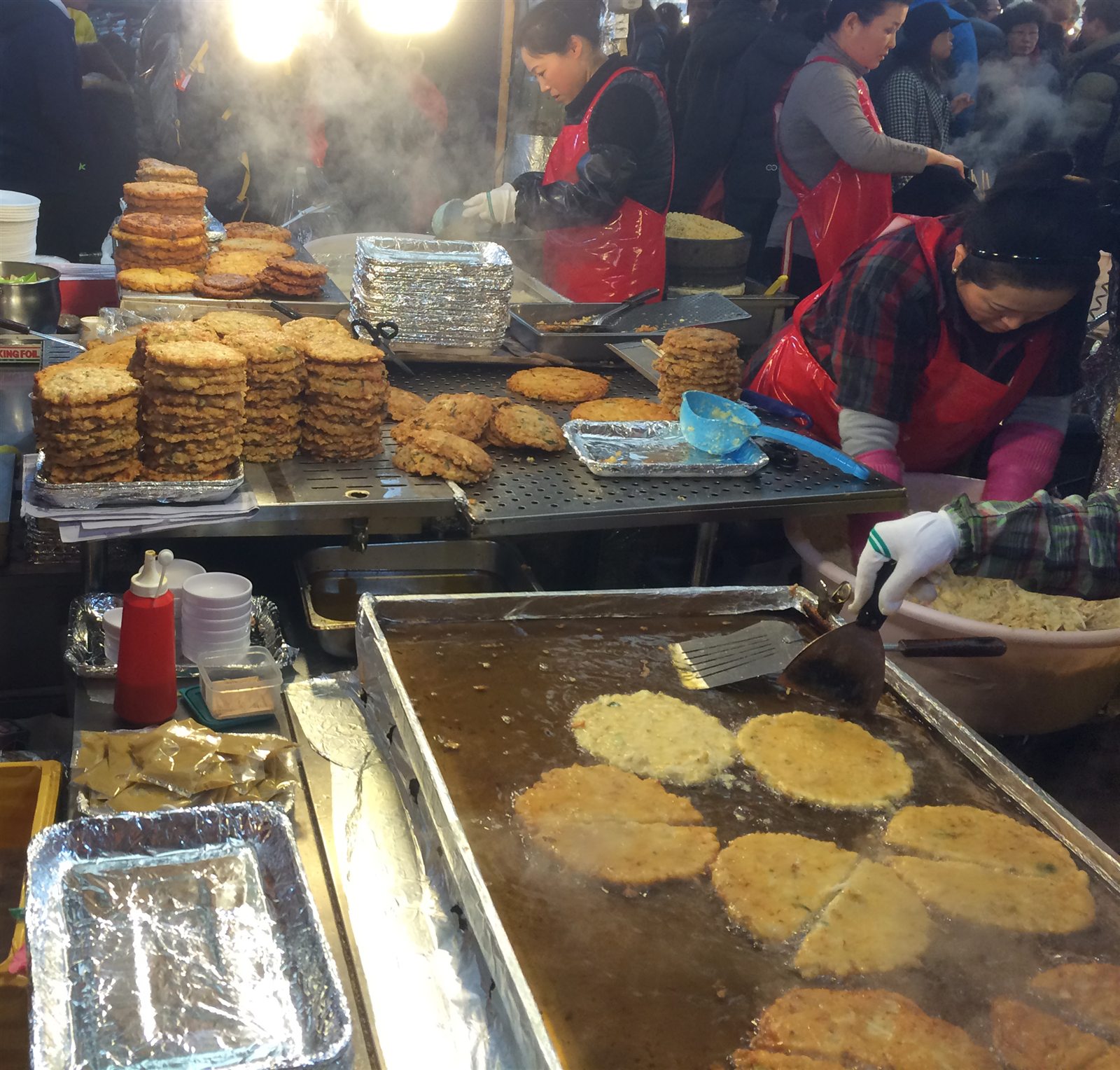 Bindaetteok mung bean pancakes frying at Gwangjang Market