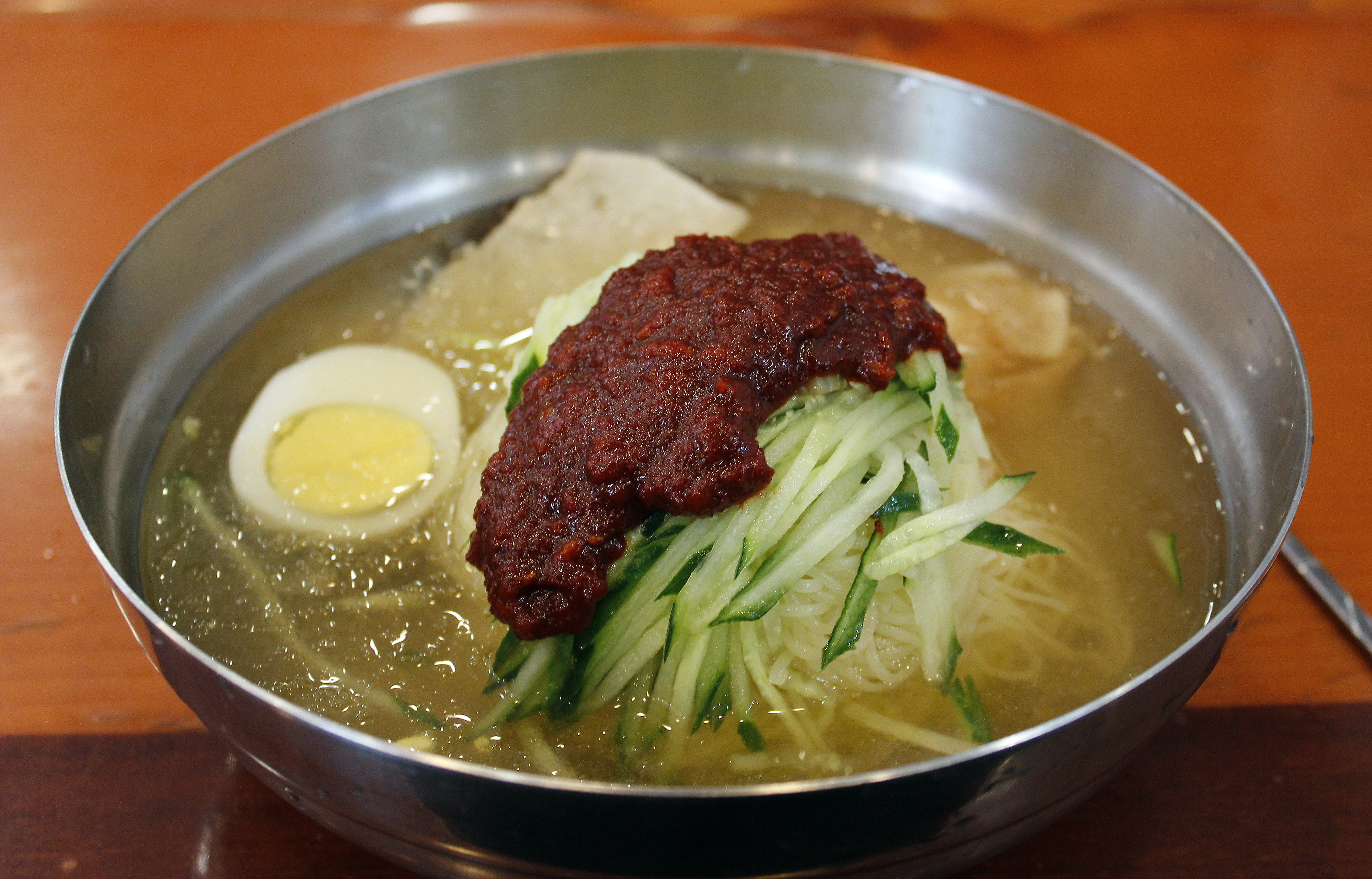 A bowl of Korean milmyeon cold noodles with garnish