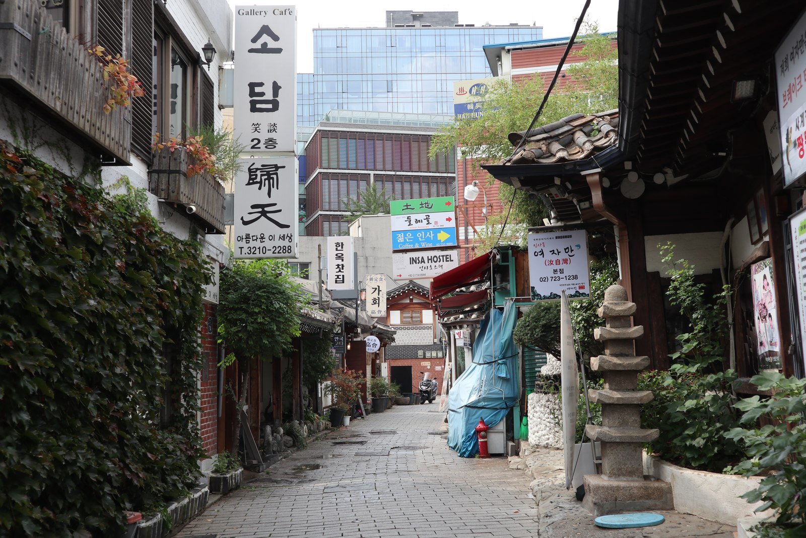 Insadong side street with traditional buildings, tea houses, and Korean signs