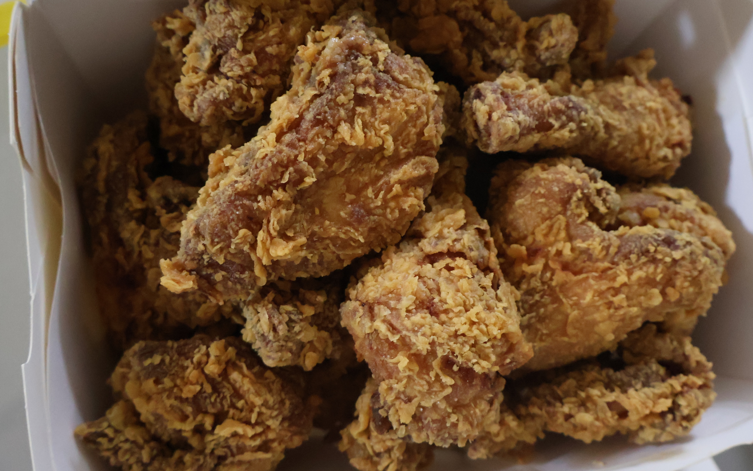 Korean fried chicken served with sauce and side dishes