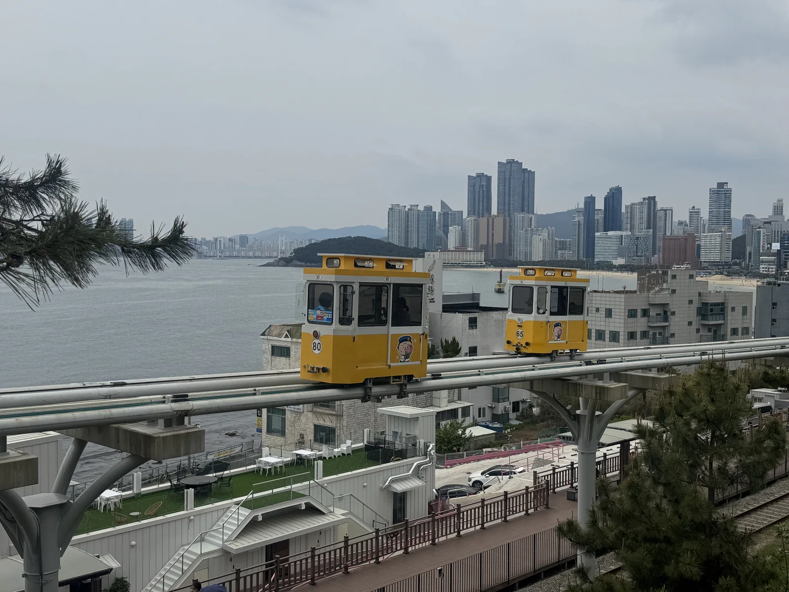 Sky Capsule trains on the Haeundae Blueline Park coastal route in Busan.
