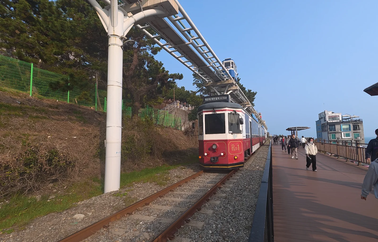 Beach Train on the Haeundae Blueline Park coastal track with the sea visible beside the walkway.