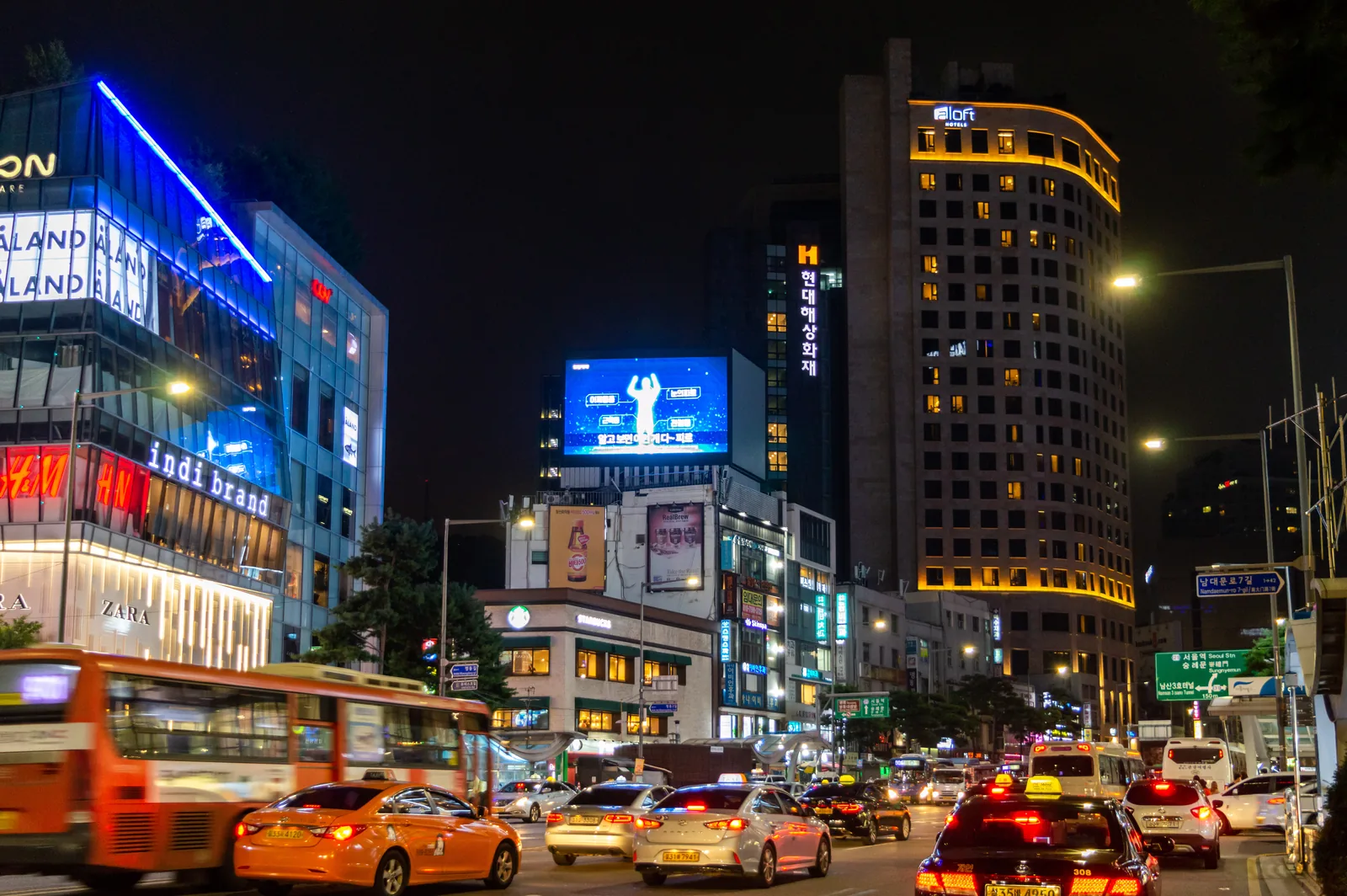 Night view of Namdaemun-ro near Myeongdong in Seoul with hotel and street lights.