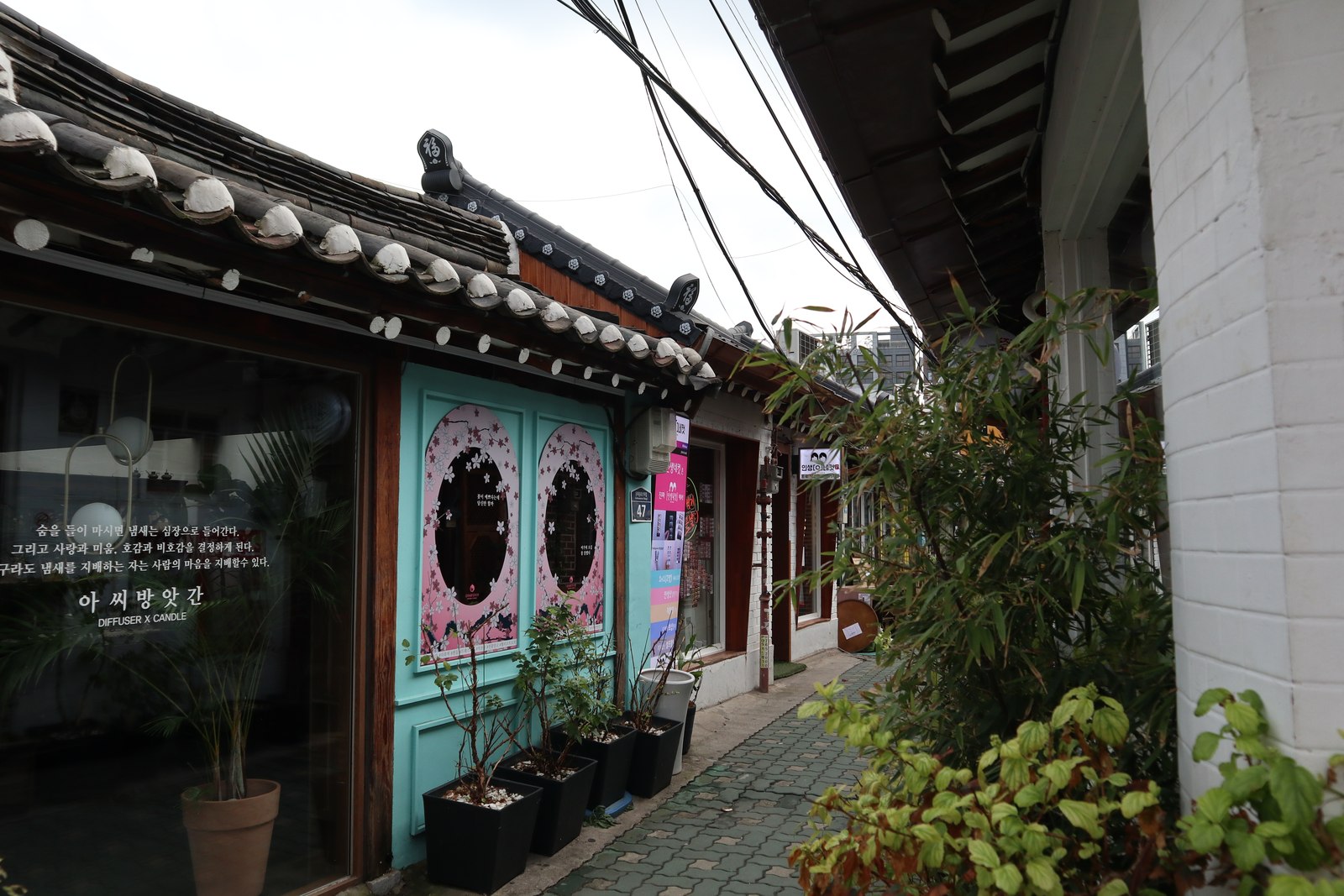 Renovated hanok storefronts along a narrow alley in Ikseon-dong