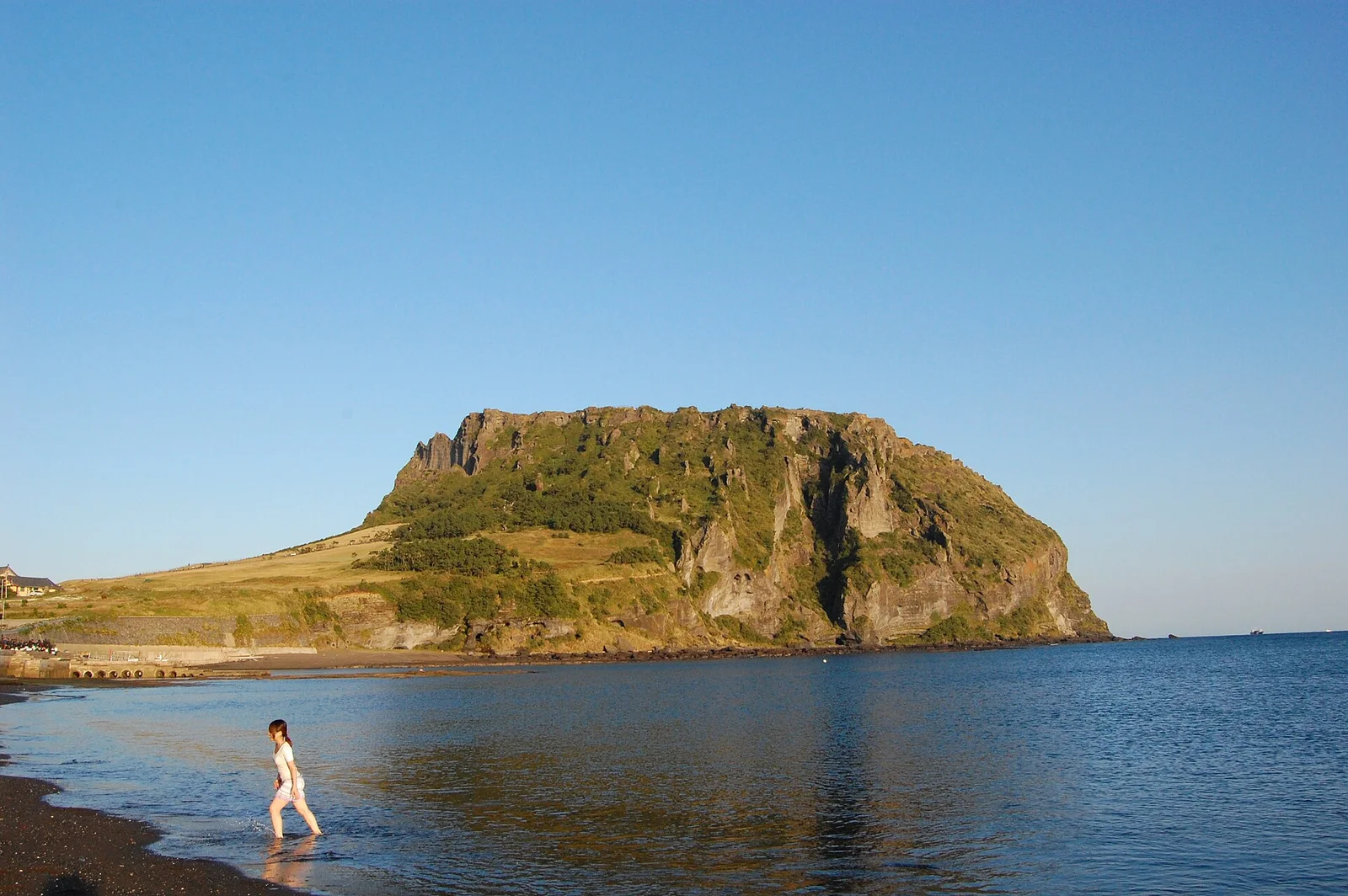 Seongsan Ilchulbong volcanic crater rising beside the coast on Jeju Island