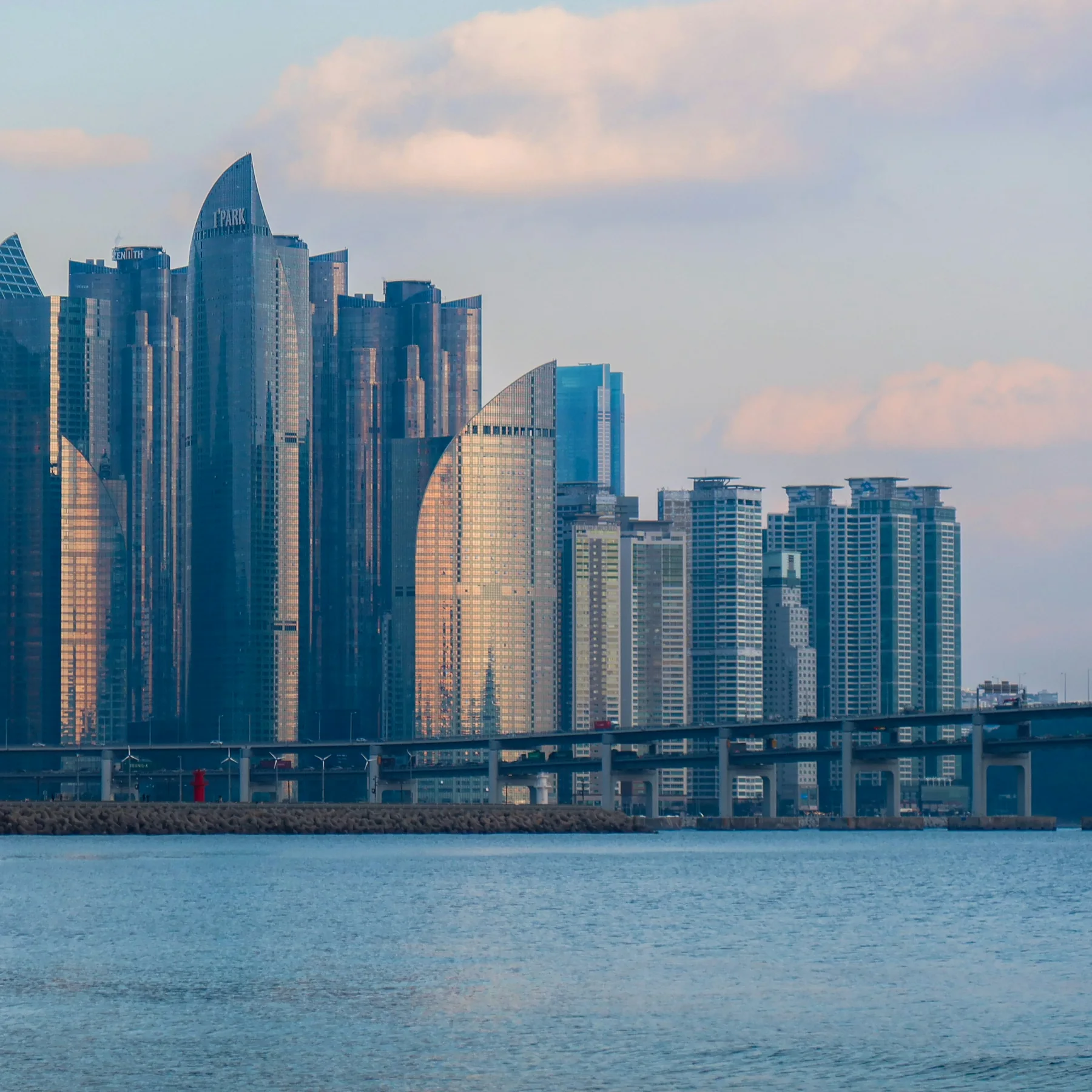 Haeundae Beach in Busan with the sea, city skyline, and beach area visible.