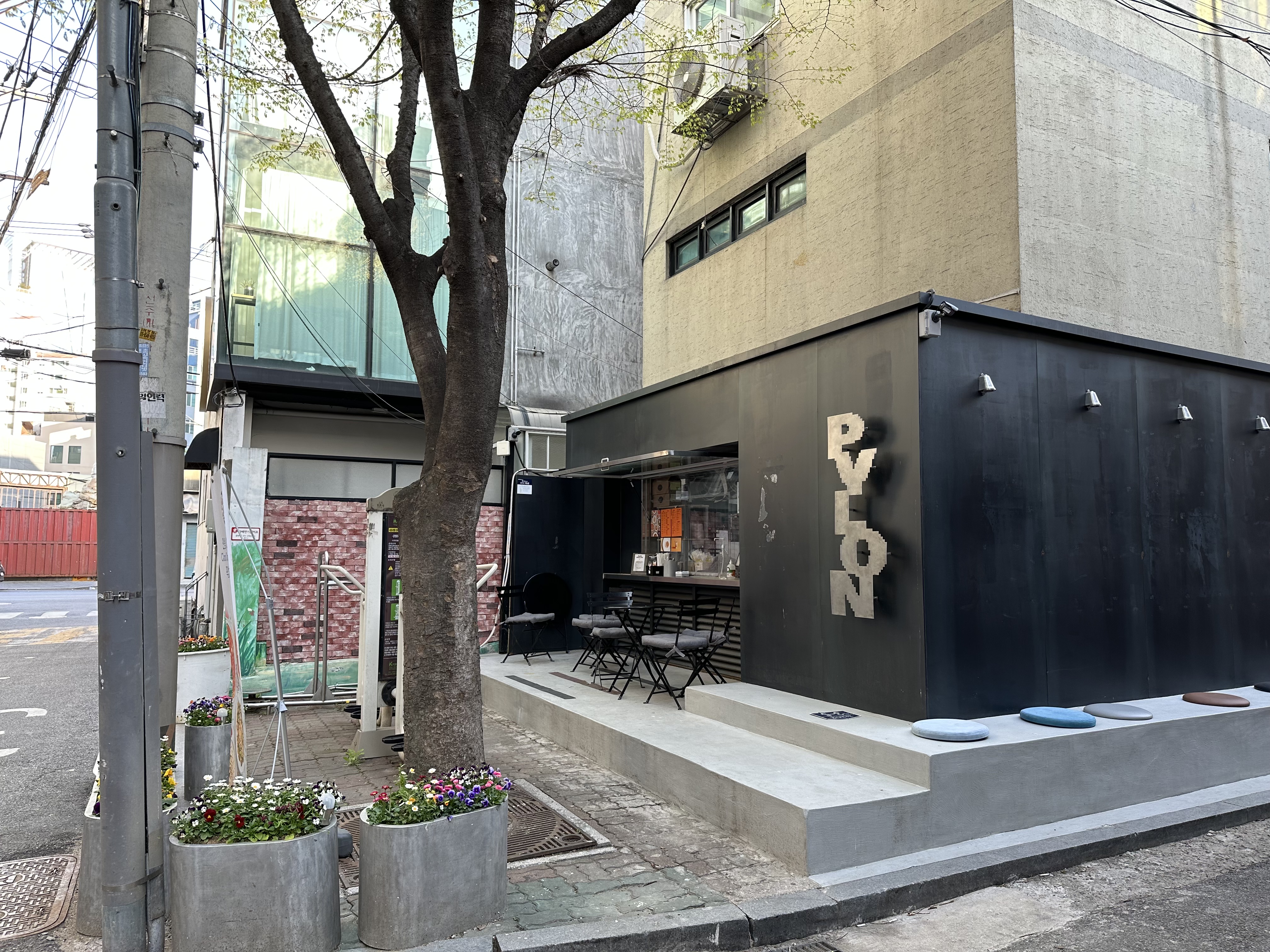 Cafe storefront in Seongsu-dong with outdoor seating and modern urban buildings