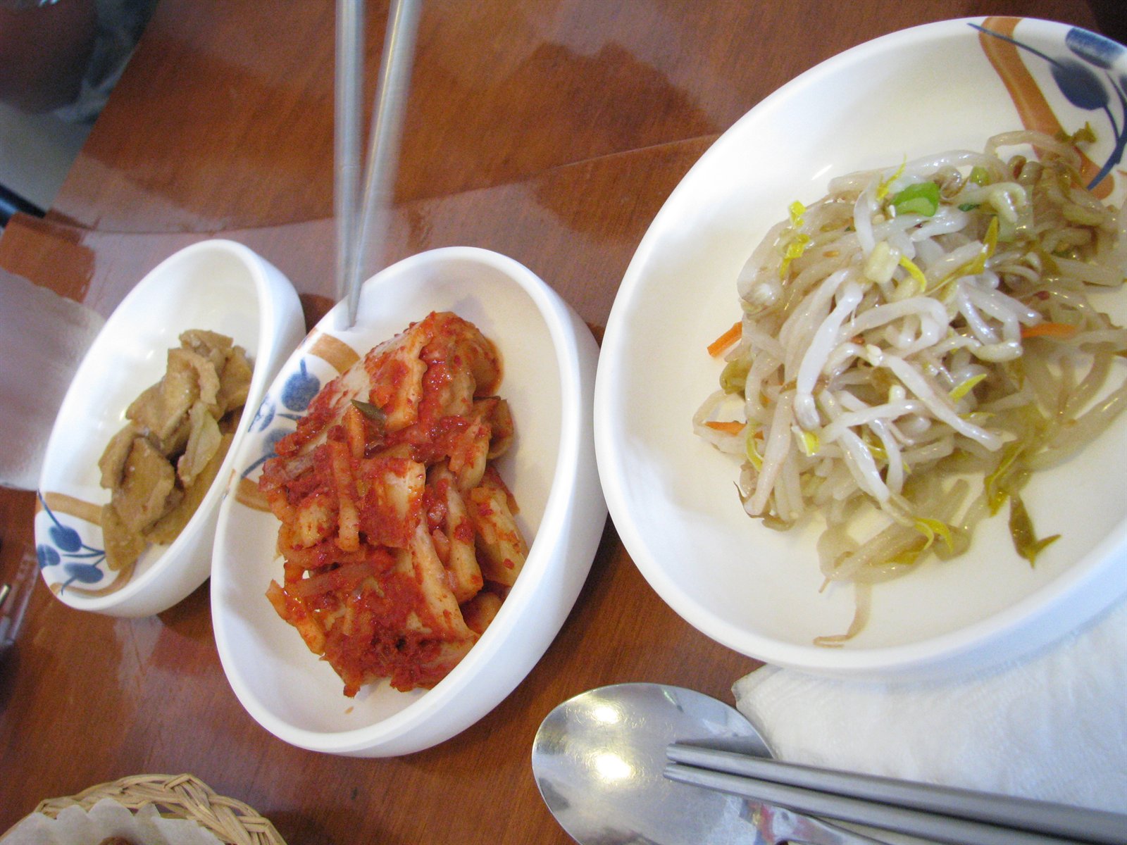 Korean side dishes including fish cake, kimchi, and seasoned vegetables