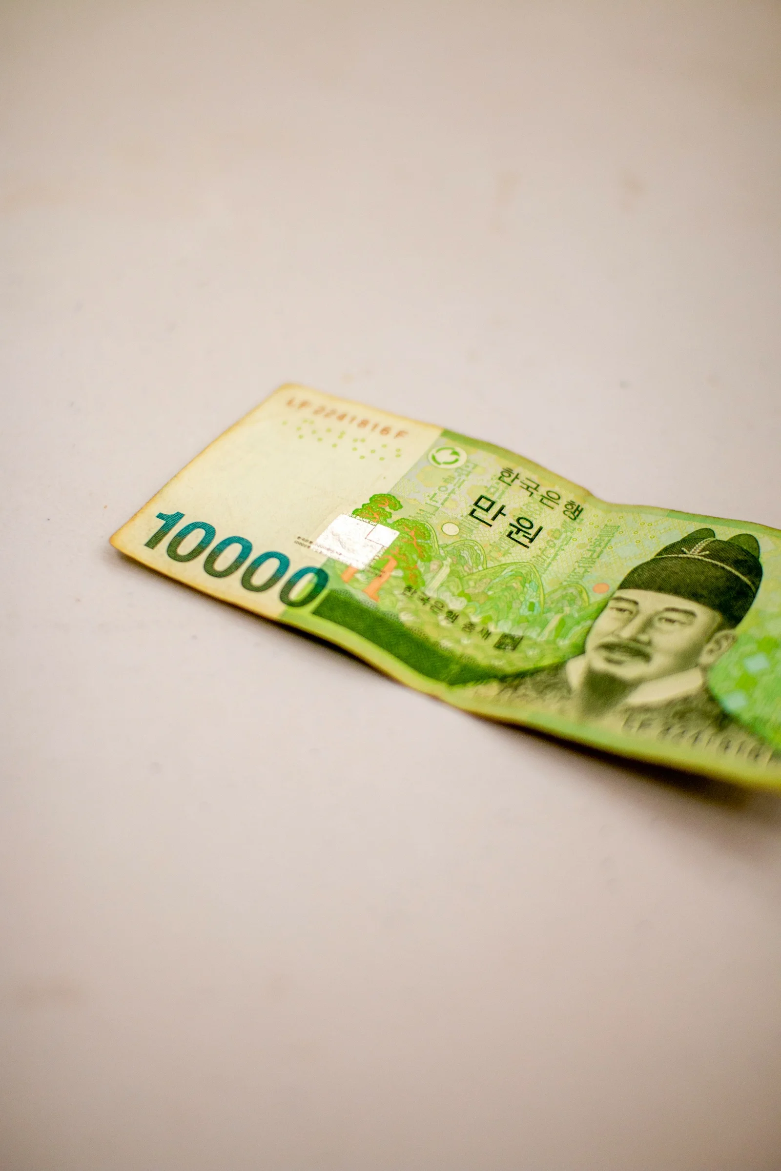 A South Korean 10,000 won banknote on a light surface